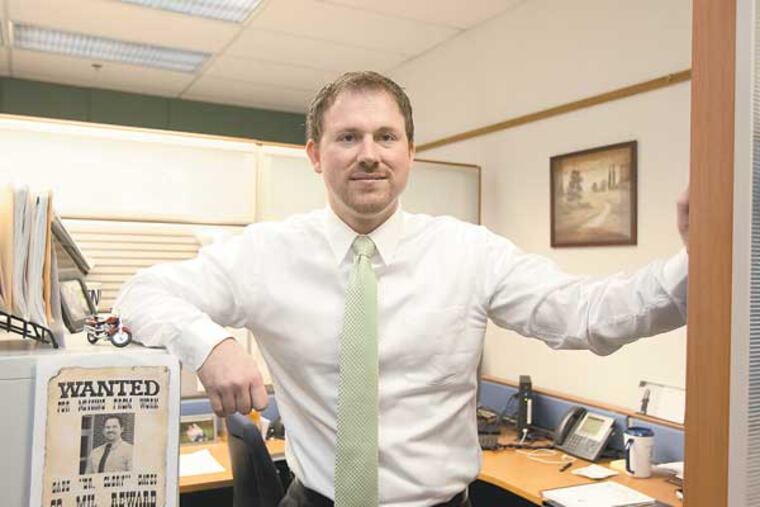 Gabriel Gates, Penn State's Clery Compliance Officer, the man charged with making sure PSU complies with the federal campus crime reporting law. Here, Gabriel Gates, stands in the doorway of his cubicle-office in the campus police department. ( ED HILLE / Staff Photographer )