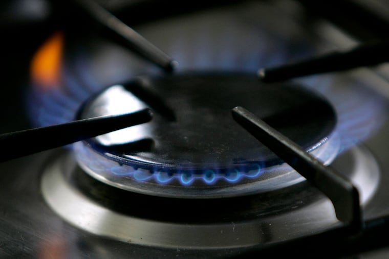 A file photo of a gas-lit flame burns on a natural gas stove.