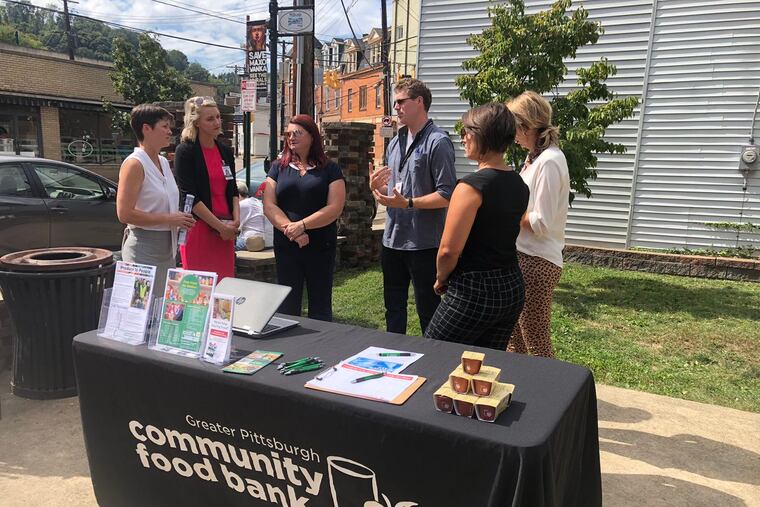 Secretary Teresa Miller, far left, of Pa.'s Department of Human Services stops at a Pittsburgh food bank for her Hunger Action Month tour, visiting organizations and volunteers across the state who are fighting food insecurity.