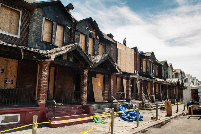 Cleanup had begun on Gesner Street on July 6, 2014 after a fire damaged eight homes and claimed the lives of four children. ( MATTHEW HALL / Staff Photographer )