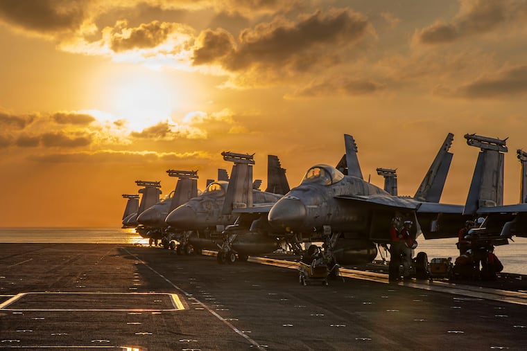 This image provided by U.S. Central Command shows aircraft on the flight deck of the USS Abraham Lincoln operating in support of the war in Iran.