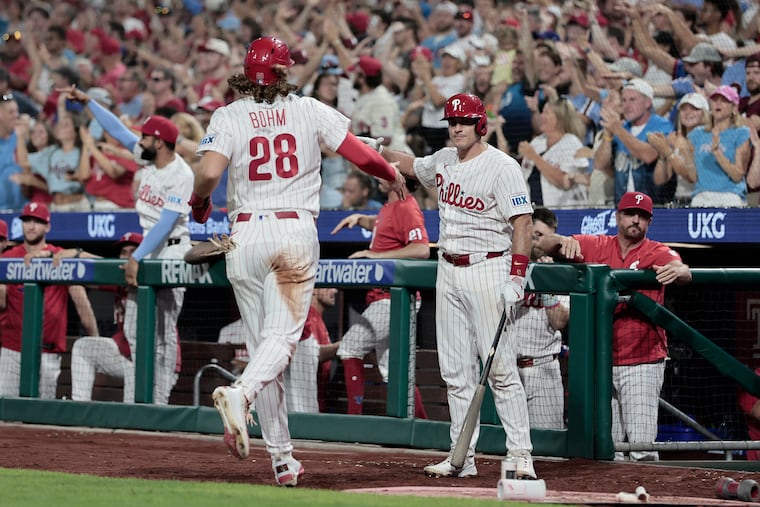 Alec Bohm (left) is greeted by J.T. Realmuto after scoring in the sixth inning on Tuesday.