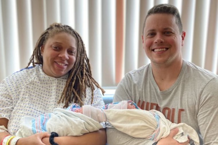 Eve and Billy of Merchantville hold their newborn twins Ezra and Ezekiel on New Year's Day 2024. The babies were born in different years at Virtua Voorhees Hospital.