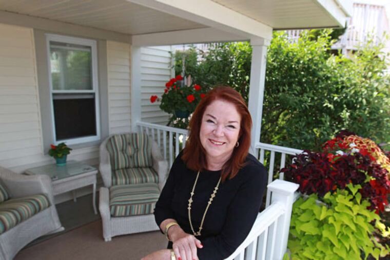 Vicki D. Lachman on her enlarged front porch, which she keeps decorated with plants. She splits her time between Florida and Avalon.