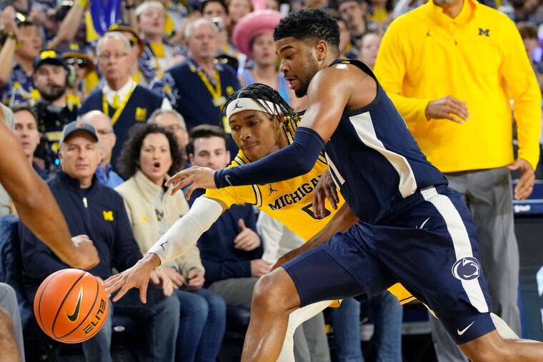 Michigan guard Dug McDaniel (0) and Penn State guard Camren Wynter (11) chase the loose ball during the second half of an NCAA college basketball game, Wednesday, Jan. 4, 2023, in Ann Arbor, Mich. (AP Photo/Carlos Osorio)