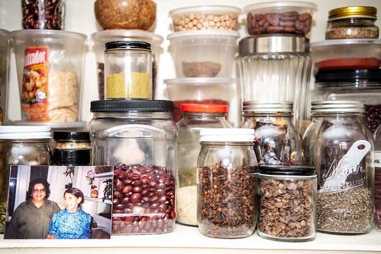 Spices in the kitchen of food writer and online cooking instructor Karla Vasquez are kept alongside a picture of her grandmother, Lucia Campos Monterrosa, and great-grandmother, Juana Campos. Spices have seen a dramatic increase in demand.
