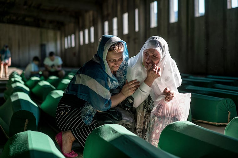 FILE — Relatives of victims of the Srebrenica massacre mourn in Potocari, Bosnia, prior to the reburial of the remains on July 10, 2016. Ratko Mladic, the former Bosnian Serb general who was captured in 2011 and convicted in international court of responsibility for the killing of some 8,000 Muslim men and boys at Srebrenica, has died, Serbian state media announced on Aug. 27, 2026. He was 83. (Andrew Testa/The New York Times).