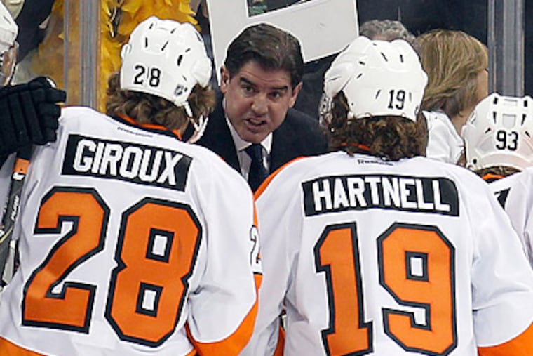Peter Laviolette talks to his team during one of his famous timeouts. (Yong Kim/Staff Photographer)