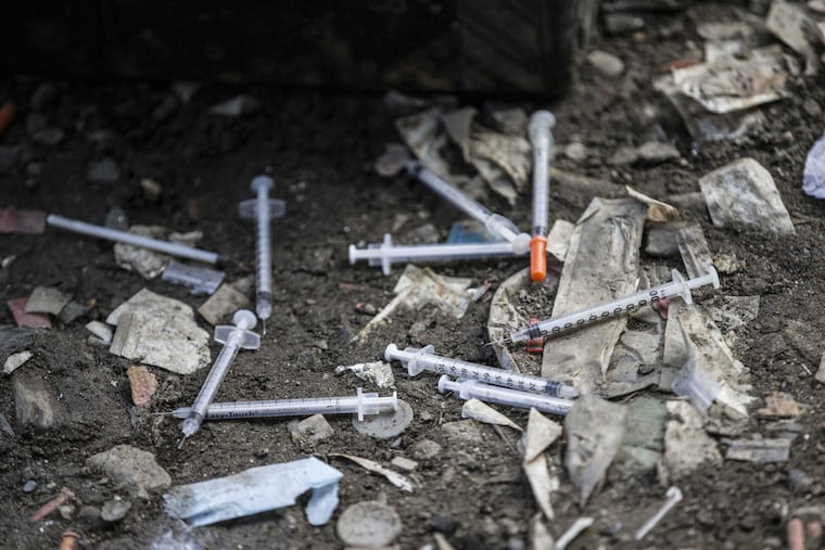 Used needles are strewn on the ground under the bridge by the train tracks in Kensington in 2017.