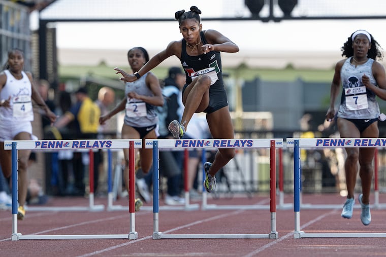Sanaa Hebron of Miami heads for a victory in the college women's 400-meter hurdles at the Penn Relays.