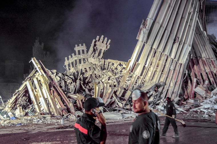 First responders work at ground zero after the Sept.11 attacks, Sept. 12, 2001, in New York.