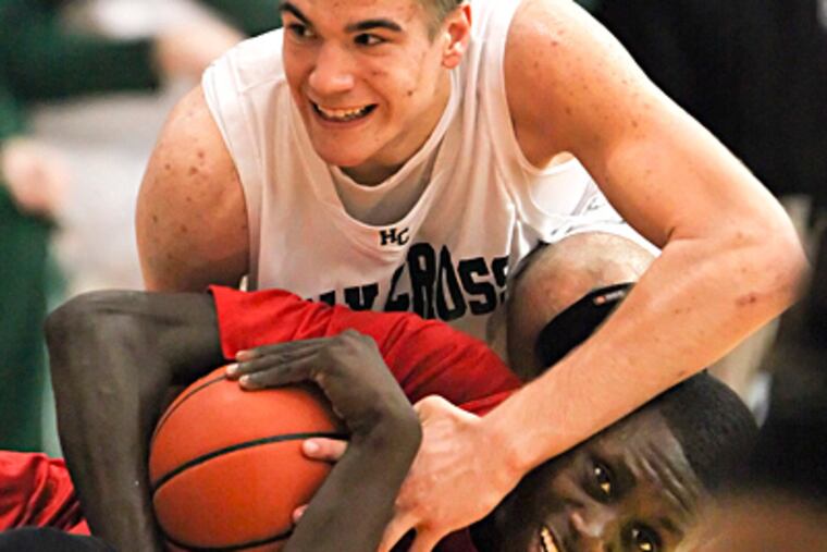 Holy Cross' Josh Kosin (top) and Imhotep's Brandon Austin battle for possession of a loose ball in the fourth quarter of the Class AA semifinal.