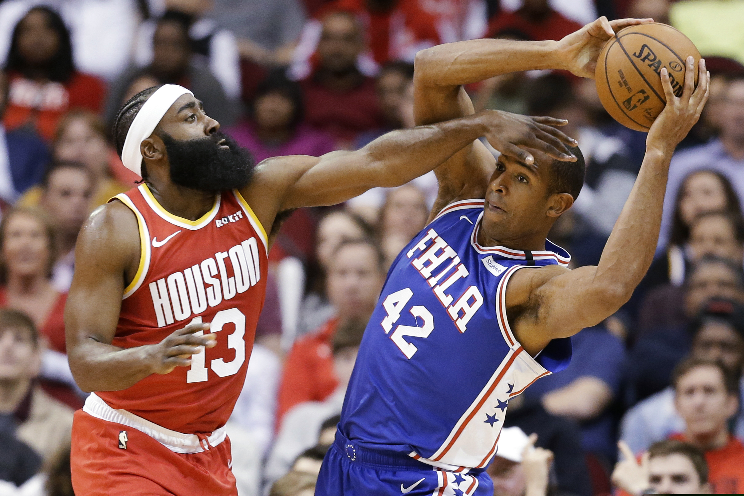 Philadelphia 76ers center Al Horford (42) looks to pass the ball as Houston Rockets guard James Harden defends during the first half of an NBA basketball game Friday, Jan. 3, 2020, in Houston.
