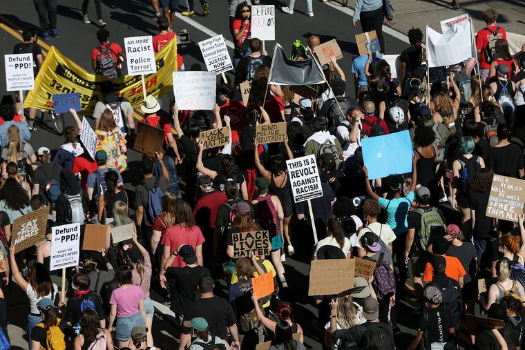 Protesters calling to defund the police march down East Market Street near Eighth Street in Center City Philadelphia on June 13, 2020. Protests against racism and police violence continued in Philadelphia for a second week following the Minneapolis police custody death of George Floyd.