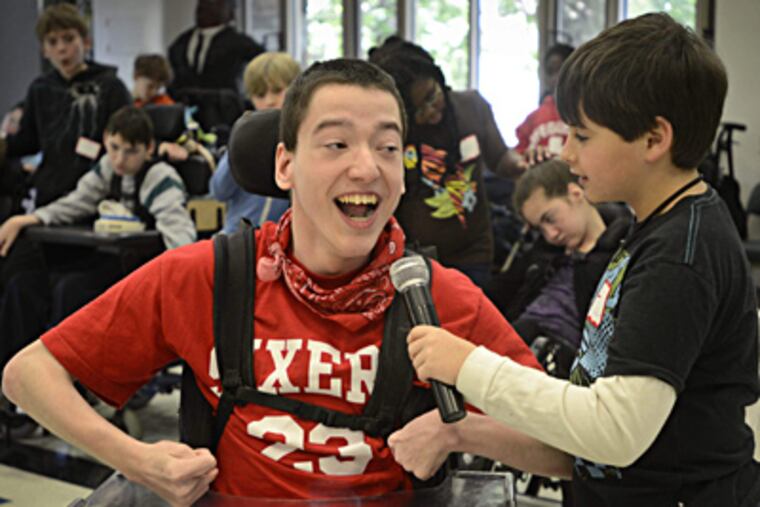 Germantown Friends student Max Marlow holds the mike for Greg Viola as they sing during dress rehearsal of the original play “On the Other Side of the Fence.” It’s the 30th anniversary “Something Magical” production with students from HMS School. RON TARVER / Staff Photographer