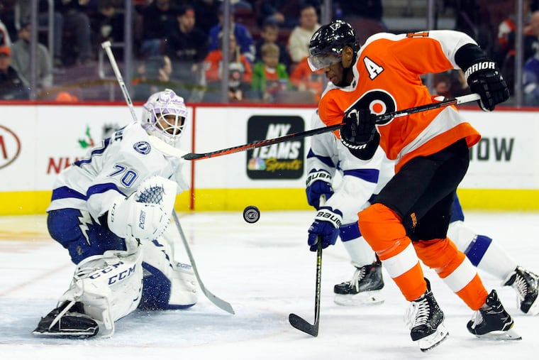 Tampa Bay goalie Louis Domingue defending against the Flyers' Wayne Simmonds in a game earlier this season.