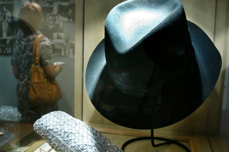 FILE - In this June 21, 2010, file photo, a hat and sequined glove once belonging to Michael Jackson are displayed at the Motown Historical Museum at Hitsville U.S.A. in Detroit. Some fans may be removing Michael Jackson’s music from their playlists after a new documentary rekindles allegations of child sexual abuse, but at least two music museums in Detroit and Tennessee aren’t scrubbing the King of Pop from their exhibits.