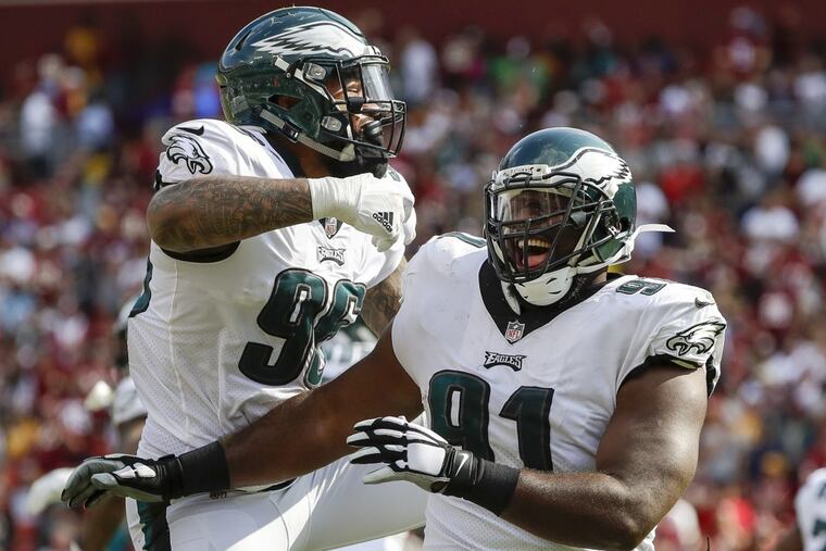 Eagles defensive tackle Fletcher Cox celebrates his touchdown fumble recovery with first-round pick Derek Barnett. The defensive front was in control for most of the game.