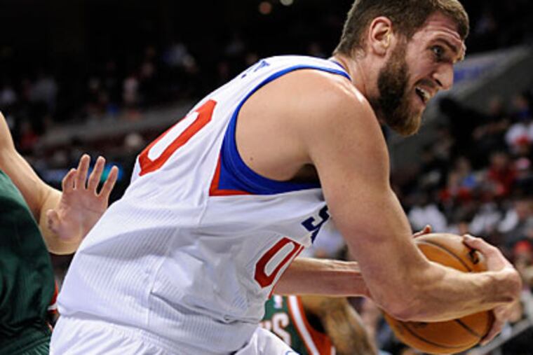 Spencer Hawes is averaging 9.2 points per game and leading the Sixers in rebounding and blocks. (Michael Perez/AP)