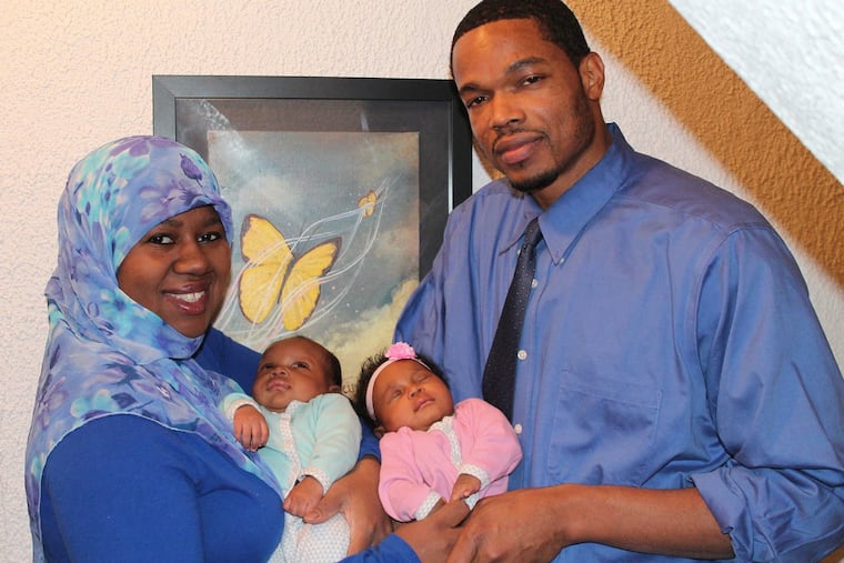 Aziz-Halim family: Mom Haajar holding Malik and dad Kamau with Laylah.