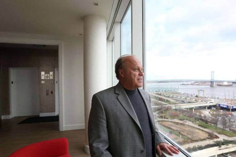 Contractor Alfred Hagen takes in the views from his 4,000-square-foot residence atop a 12-story boutique building in Society Hill. He recently relocated from Bucks.