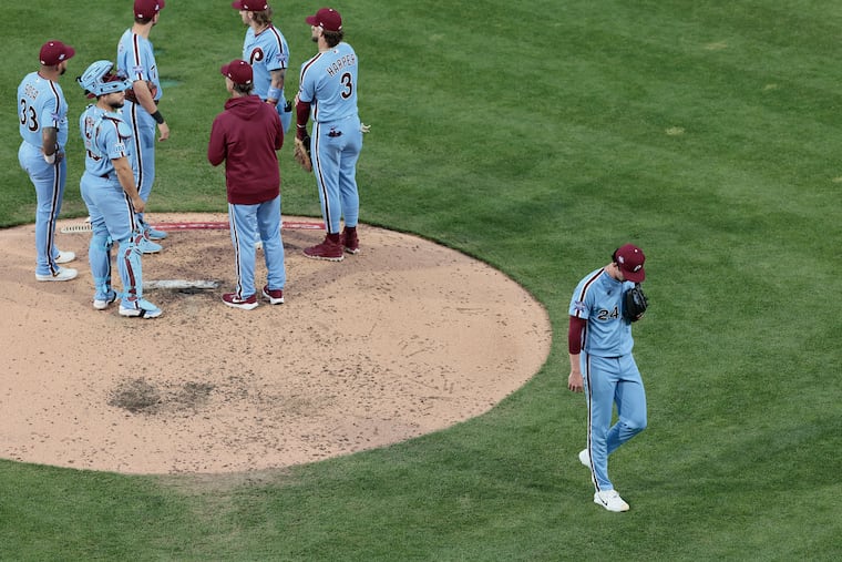 Andrew Painter (right) is pulled from the game in the fourth inning of a 12-1 loss to the A's.