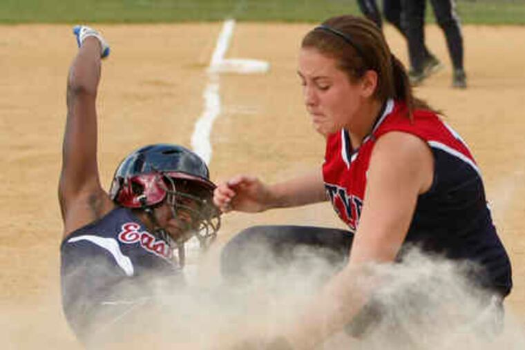 Washingtown Township pitcher Alissa Schoelkopf can't get the tag down as Eastern's Cherelle Chambers scores from second on her wild pitch in the fourth to give the Vikings the lead.