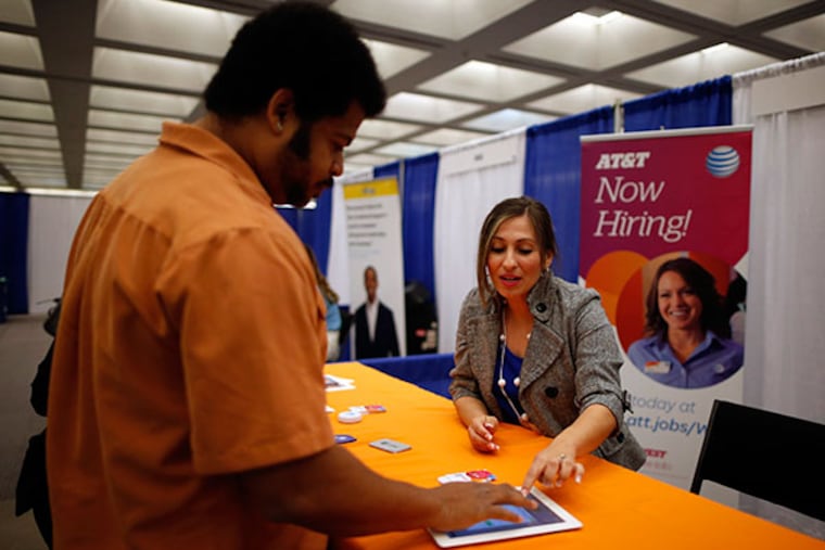 AT&T hiring manager Cathy Zavala (R) talks to Jose Blackman, 38, who was laid off last year and is looking for a job to support his two children, in Los Angeles, California April 9, 2014. (REUTERS/Lucy Nicholson)