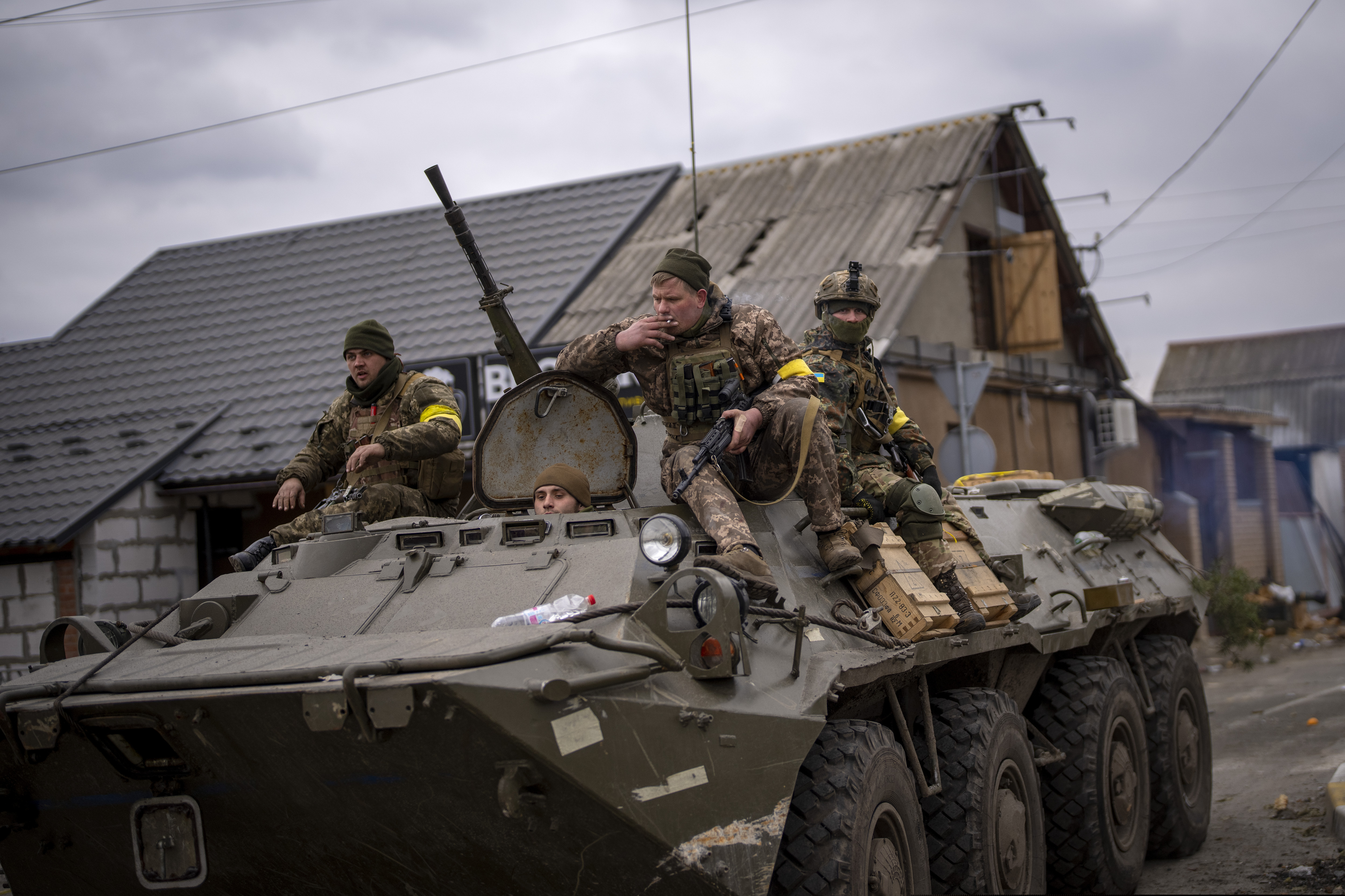 Ukrainian soldiers on an armored military vehicle in the outskirts of Kyiv on Saturday.