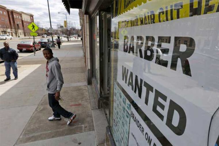 A help-wanted sign at a barbershop in Richmond, Va. U.S. employers added just 88,000 jobs in March, the fewest number in nine months. (Steve Helber / Associated Press)