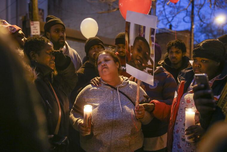 Rasheida Quinn gets support from family and friends for her murdered son, Demitrius Moore, last Monday on the 3100 block of North Rosewood Street. Moore, 15, was shot and killed the day before.