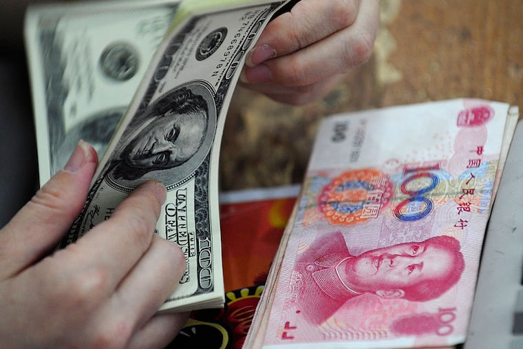 The yuan and the dollar: Analysts are debating the effects of China's devaluing of its currency after its market crash. AP