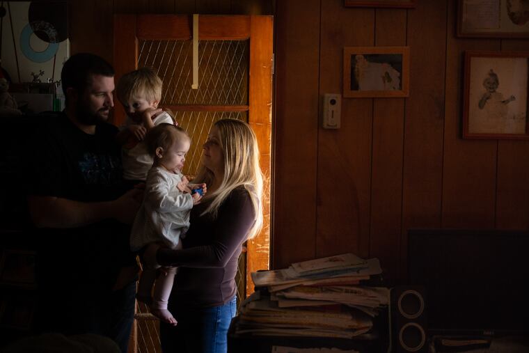 Maggie Sabatino stands in her home with her husband, John, and their children, Callen (left), 3, and Kensi, 1, in their home in the Pennsport section of South Philadelphia. Sabatino is a TSA staffer working without pay due to the national government shutdown.