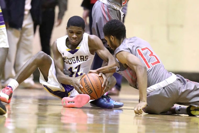 Hyseir Miller (left), shown fighting for a loose ball in a game against Imhotep Charter last season, scored 17 points in Martin Luther King's win against Overbrook on Monday.