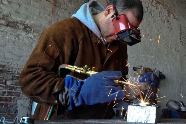 Gustavo Actis uses the welding equipment at the Philadelphia Sculpture Gym, an artist's collaborative where sculptors have access to heavy-duty industrial tools need to make their art. Janurary 1, 2013 ( RON TARVER / Staff Photographer )