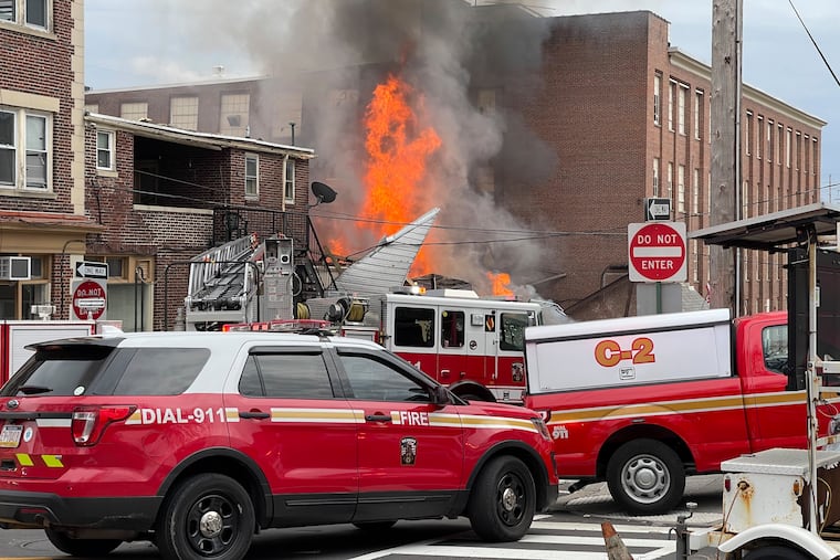 Emergency personnel work at the site of a deadly explosion at a chocolate factory in West Reading, Pa., March 25, 2023.
