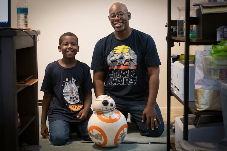 Keith Yarde (left) and his dad, Kerwin, at their King of Prussia home with their pal, BB-8.