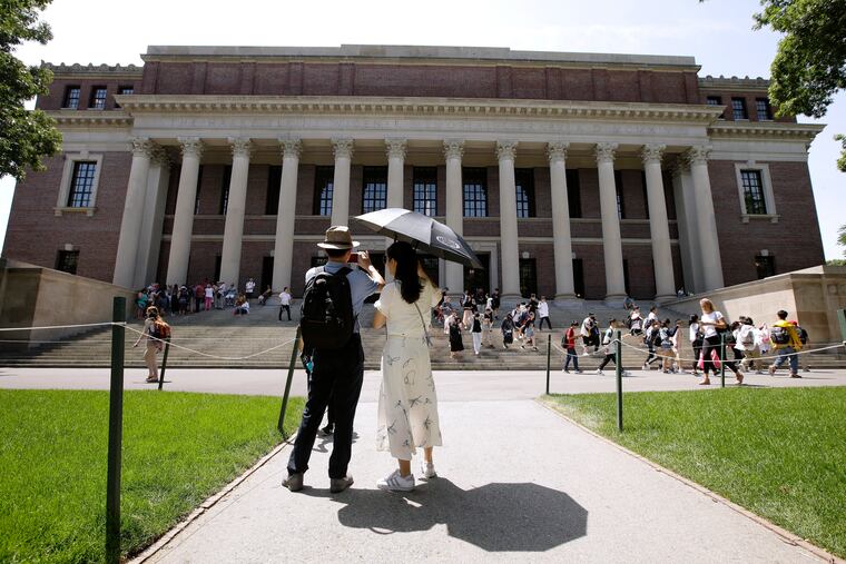 In this July 16, 2019, file photo, people stop to record images of Widener Library on the campus of Harvard University in Cambridge, Mass. U.S. District Judge Allison D. Burroughs ruled, Tuesday, Oct. 1, 2019, that Harvard does not discriminate against Asian Americans in its admissions process. The judge issued the ruling in a 2014 lawsuit that alleged Harvard holds Asian American applicants to a higher standard than students of other races. Burroughs said Harvard's admissions process is not perfect but passes constitutional muster.