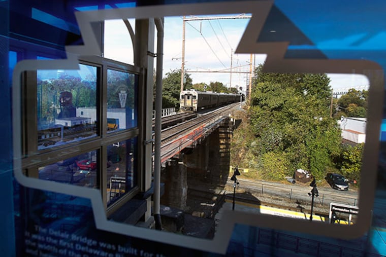 A New Jersey Transit train bound for Philadelphia leaves the new transportation center in Pennsauken, NJ on October 14, 2013. The train is seen through a window at the station. A dedication ceremony was held there on Monday. ( DAVID MAIALETTI / Staff Photographer )