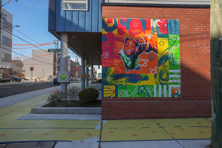 The Live and Learn initiative brought a mural and painted sidewalk to an educational outdoor play space at 2045 Master St. in Sharswood.