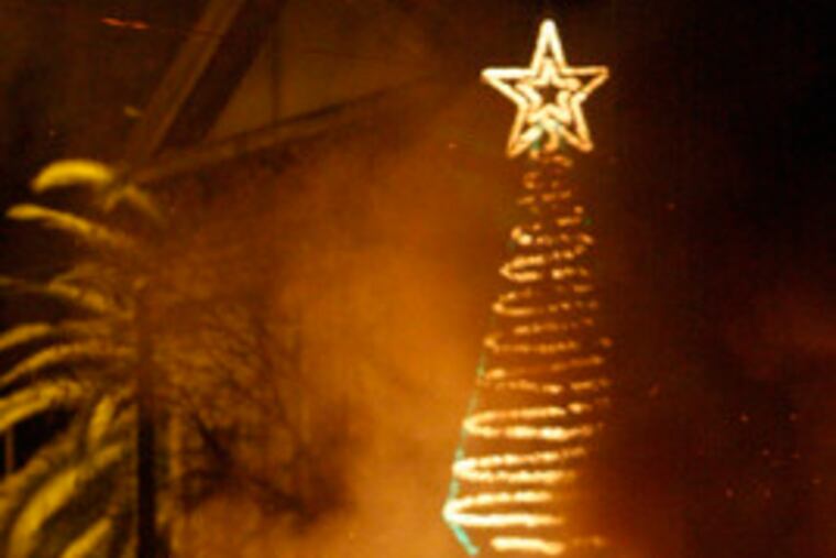 A rioter approaches police during clashes in Athens. The violence yesterday followed a memorial gathering where Alexandros Grigoropoulos, 15, died Dec. 6, sparking riots.