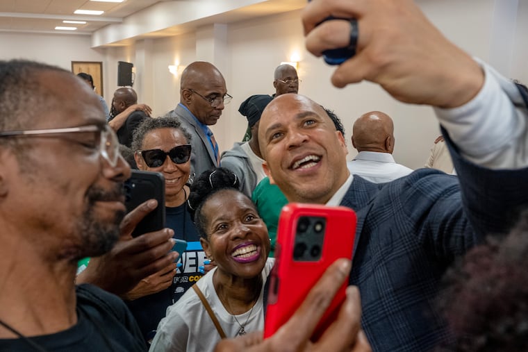 U.S. Sen. Cory Booker takes selfies with supporters following a get-out-the-vote rally for State Sen. Sharif Street at the Church of Christian Compassion in West Philadelphia on May 18.