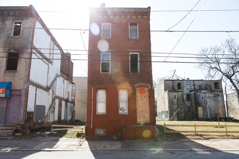 A house sits vacant with its windows boarded up on the 2400 block of Oxford Street in North Philadelphia on Wednesday morning, February 14, 2018. SYDNEY SCHAEFER / Staff Photographer