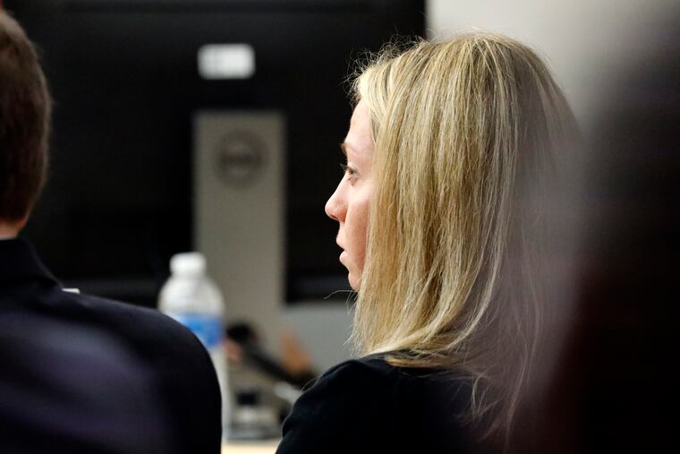 Fired Dallas police officer Amber Guyger listens as friends, family and coworkers speak in her defense during the sentencing phase of her murder trial, Wednesday, Oct. 2, 2019, in Dallas. Guyger, who said she fatally shot her unarmed, black neighbor Botham Jean after mistaking his apartment for her own, was found guilty of murder the day before.