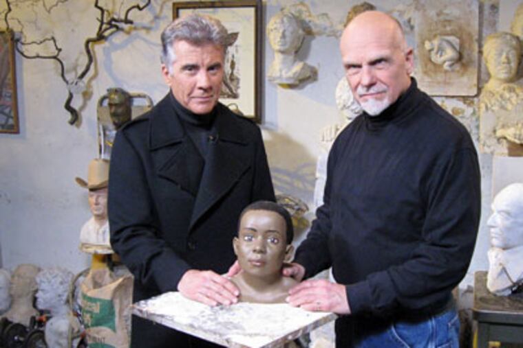 John Walsh (left), host of "America's Most Wanted," with Frank Bender, renowned forensic sculptor, in Bender’s studio/home on South Street this week. (Peter Mucha / Staff Photographer)
