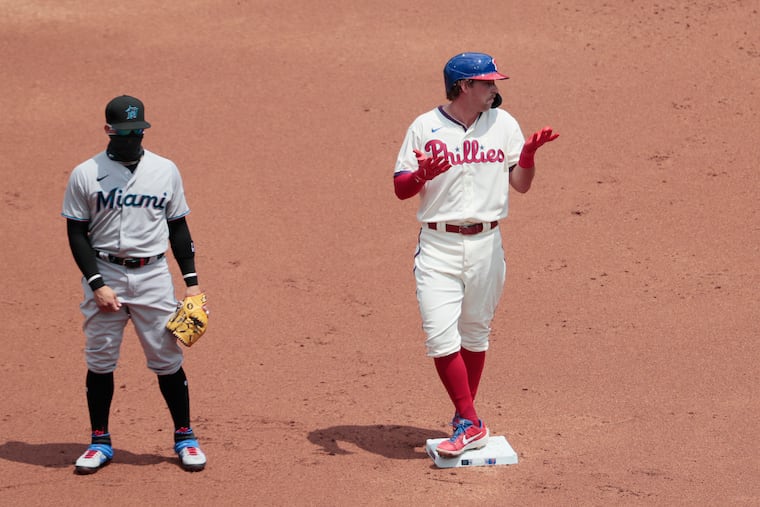 With a Marlins player covering second base, Phils Rhys Hoskins gestures to the dugout after hitting a double during the Philadelphia Phillies vs. the Miami Marlins MLB game on Sunday.