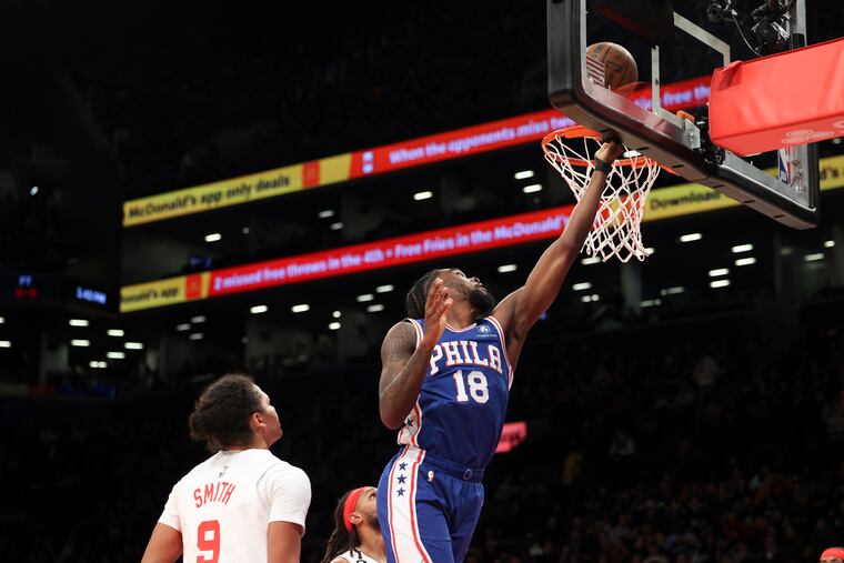 Philadelphia 76ers guard Shake Milton (18) scores a basket as Brooklyn Nets guard Dru Smith (9) watches.