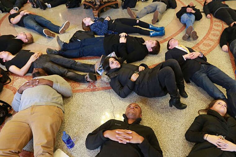 About 60 students at Penn Law School hit the floor for 41/2 minutes Tuesday to protest the Michael Brown case. (DAVID SWANSON / Staff Photographer)