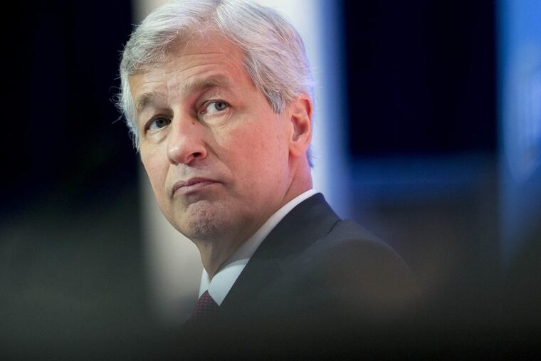 Bloomberg Photo Service 'Best of the Week': James "Jamie" Dimon, chief executive officer of JPMorgan Chase & Co., listens during an Institute of International Finance panel discussion in Washington, D.C., U.S., on Friday, Oct. 10, 2014. Dimon, who's making his first public appearance since undergoing treatment for throat cancer earlier this year, said the biggest U.S. bank probably will double its $250 million annual computer-security budget within the next five years. Photographer: Andrew Harrer/Bloomberg *** Local Caption *** Jamie Dimon