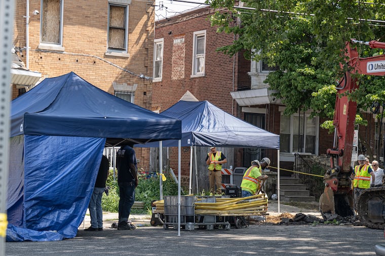 Workers and police investigators dig and inspect a hole while removing pipes and debris at the entrance to the home of Eugene Albert Horsch on West Chew Avenue in the Olney section of Philadelphia as investigators search for possible evidence Wednesday, July 22, 2026.